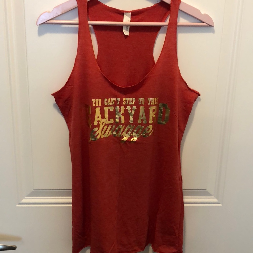 Red tank with “You Can’t Step To This Backyard ...